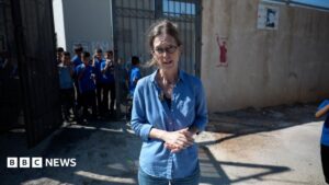 Pupils return to West Bank school behind barbed wire to protect against settlers